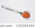 Red trout caviar on a silver spoon 135294344