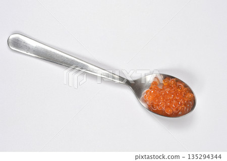 Red trout caviar on a silver spoon 135294344