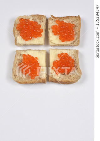 Trout caviar canapes on white background 135294347