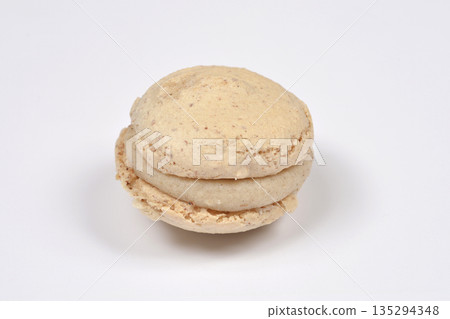 Single french macaroon cookie isolated on white Single french macaroon cookie isolated on white 135294348
