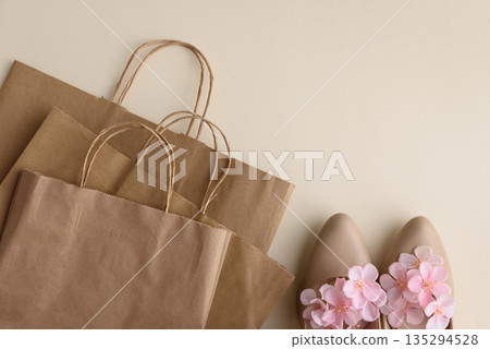 Shopping Eco Bags and Floral High Heels on Beige Background. Festive Spring Fashion Flatlay Shopping Eco Bags and Floral High Heels on Beige Background. Festive Spring Fashion Flatlay 135294528