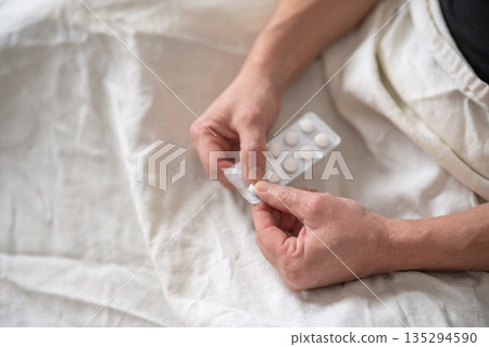 Blister pack of pills in senior man hands Blister pack of pills in senior man hands 135294590