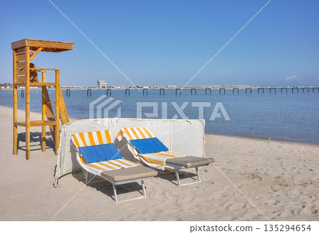 Beach with a lifeguard tower and sun loungers, Hurghada, Egypt. 135294654