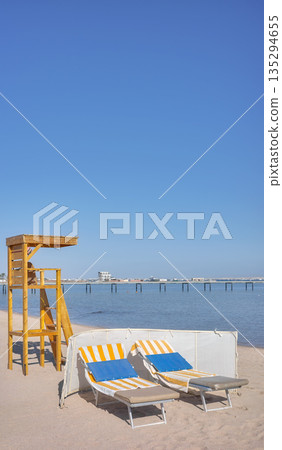 Beach with a lifeguard tower and sun loungers, Hurghada, Egypt. 135294655