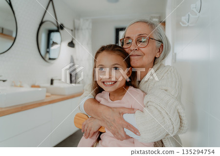 Grandmother taking care of granddaughter during holidays. Grandmother taking care of granddaughter during holidays. 135294754