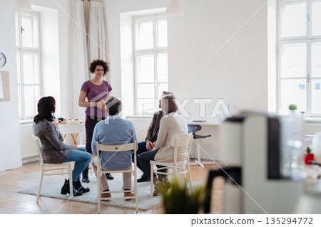 Woman speaking about her success during guided therapeutic session. 135294772