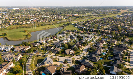 Aerial view of suburban neighborhood with lake Aerial view of suburban neighborhood with lake 135295005