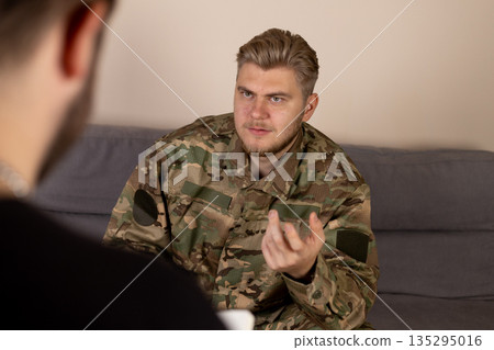 Soldier talking to therapist on the sofa Soldier talking to therapist on the sofa 135295016