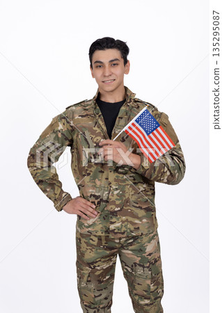Soldier in camouflage uniform holding American flag 135295087