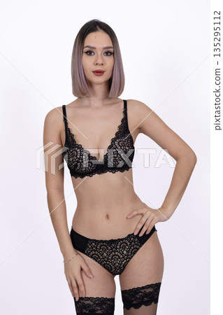 Woman in black lingerie with hands on her hips 135295112