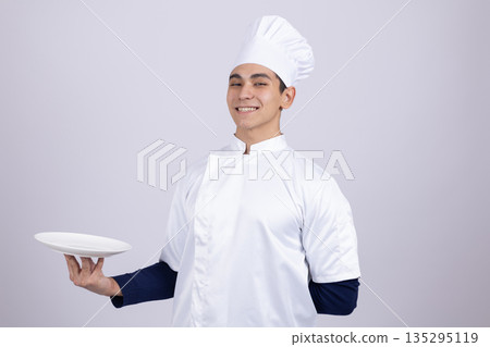 Professional chef holding empty plate for serving 135295119