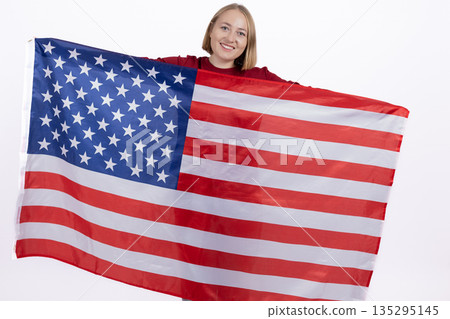 Smiling woman draped in the United States flag Smiling woman draped in the United States flag 135295145