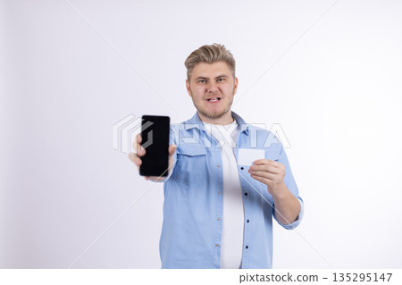 Happy young man holding smartphone for social media 135295147