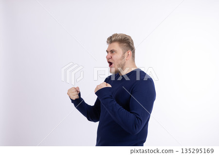 Man in blue sweater pointing at himself with thumbs Man in blue sweater pointing at himself with thumbs 135295169