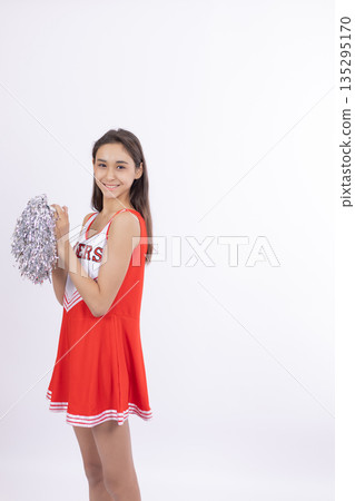 Cheerleader girl in red uniform posing sideways 135295170