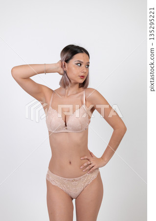 Young woman in lingerie posing with hands on head Young woman in lingerie posing with hands on head 135295221