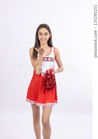 Cheerful cheerleader woman in red uniform 135295251