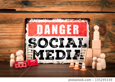 Danger Social Media Concept With Wooden Figures And Warning Scene Elements Danger Social Media Concept With Wooden Figures And Warning Scene Elements 135295339