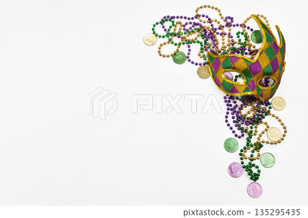 Mardi gras mask and beads celebrating carnival festival Mardi gras mask and beads celebrating carnival festival 135295435