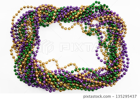 Mardi gras beads border framing white background Mardi gras beads border framing white background 135295437