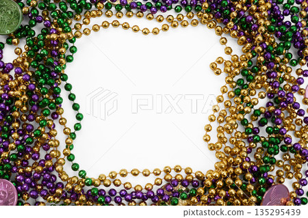 Mardi gras beads framing white copy space background Mardi gras beads framing white copy space background 135295439
