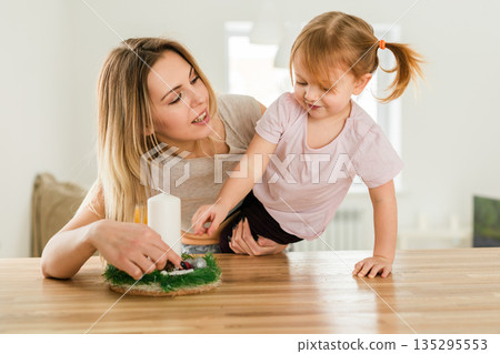 Mother with her little daughter in bright kitchen interior. Family joy, emotional closeness, and lighthearted connection in daily life. Mother with her little daughter in bright kitchen interior. Family joy, emotional closeness, and lighthearted connection in daily life. 135295553