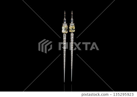 beautiful earrings with gemstones yellow sapphire and diamonds on a black background beautiful earrings with gemstones yellow sapphire and diamonds on a black background 135295923