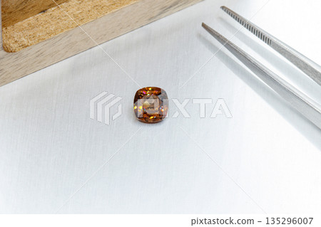 macro mineral faceted stone cut Zircon on a gray background 135296007