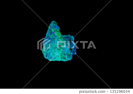 macro mineral stone opal under ultraviolet light on a black background macro mineral stone opal under ultraviolet light on a black background 135296034