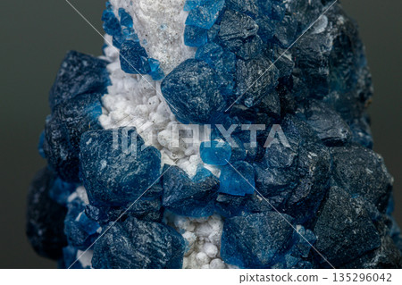 macro mineral stone Fluorite on quartz on a gray background macro mineral stone Fluorite on quartz on a gray background 135296042
