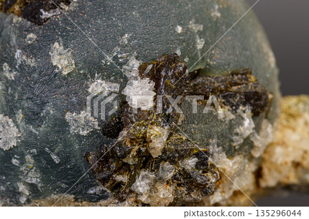 macro mineral stone Prehnite on Epidote on a gray background macro mineral stone Prehnite on Epidote on a gray background 135296044