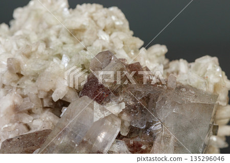 macro mineral stone Apophyllite stilbite on a gray background macro mineral stone Apophyllite stilbite on a gray background 135296046