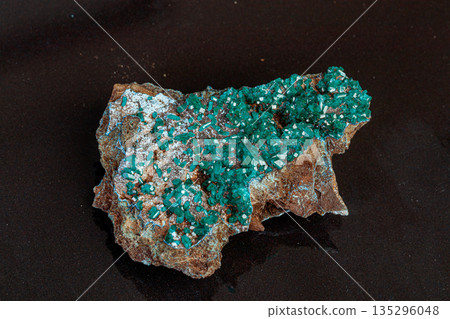 macro mineral stone Dioptase on a gray background 135296048