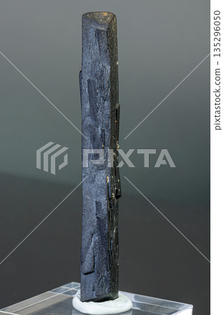 macro mineral stone Ilvaite on a gray background 135296050