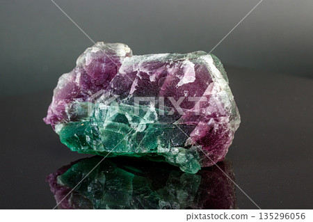 macro mineral stone red and green fluorite on a black background 135296056