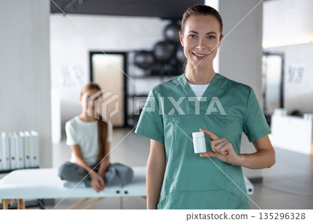 Professional healthcare showing treatment container during consultation Professional healthcare showing treatment container during consultation 135296328