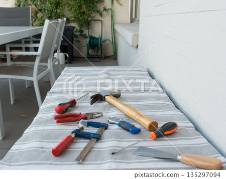 Set of tools on a terrace table Set of tools on a terrace table 135297094