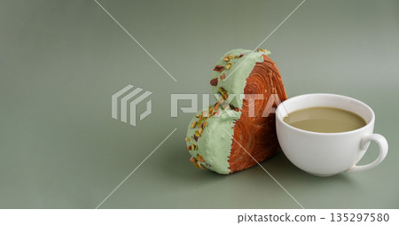 Drink beverage coffee cappuccino latte Delicious fresh croissant topped with Matcha Green Tea flavor Ganache. Creation unique heart shape bakery. Puff pastry holiday love gift present idea Valentine's 135297580