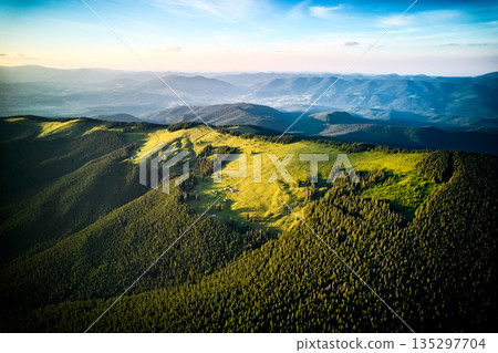 Aerial view of mountain hills covered pine forest. 135297704