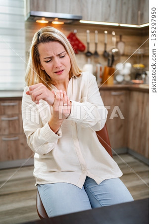 Experiencing discomfort at home while multitasking in the kitchen Experiencing discomfort at home while multitasking in the kitchen 135297950