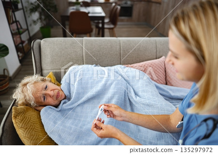 Caring touch inspires hope during a tender moment in a cozy living room 135297972