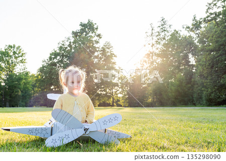 Airplane costume. Toddler imagination flying. Girl outdoor yello Airplane costume. Toddler imagination flying. Girl outdoor yello 135298090