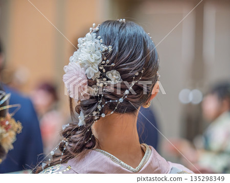 Back view of a woman wearing a beautiful kimono at the Coming of Age Ceremony Back view of a woman wearing a beautiful kimono at the Coming of Age Ceremony 135298349