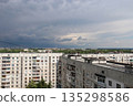 A panoramic urban view of a residential district in Kharkiv, Ukraine, featuring typical multi-story concrete apartment blocks. 135298586