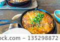 Hot cutlet with egg served in an iron pot 135298872