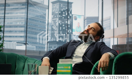 Concerned CEO taking an aspirin to ease the headache due to stress, feeling a discomfort and using painkillers. Tired uncomfortable boss deals with a migraine, burnout and tension. Camera A. Concerned CEO taking an aspirin to ease the headache due to stress, feeling a discomfort and using painkillers. Tired uncomfortable boss deals with a migraine, burnout and tension. Camera A. 135299855