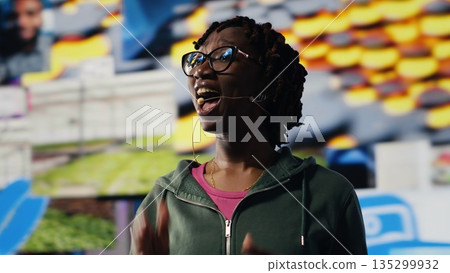 Young woman watching content on video streaming services, enjoying leisure time using laptop. Teenager looking at entertaining VOD broadcasts on notebook software, camera B Young woman watching content on video streaming services, enjoying leisure time using laptop. Teenager looking at entertaining VOD broadcasts on notebook software, camera B 135299932