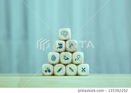 healthcare,wellness plan and insurance concept, Health, care and medical icon symbols stacking on wood block. blocks on blue background with space. healthcare,wellness plan and insurance concept, Health, care and medical icon symbols stacking on wood block. blocks on blue background with space. 135302202