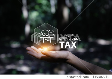 hand holding a digital interface with "TAX" and a CO2 cloud icon, representing the concept of carbon tax and its role in promoting a green, sustainable economy. hand holding a digital interface with "TAX" and a CO2 cloud icon, representing the concept of carbon tax and its role in promoting a green, sustainable economy. 135302210