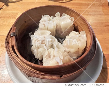 Delicious looking shumai in a bamboo steamer Delicious looking shumai in a bamboo steamer 135302440